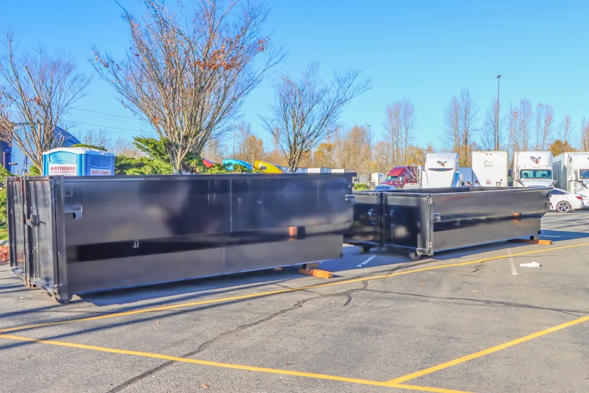 Professional dumpster rental service with roll-off container on residential driveway in Elizabeth City